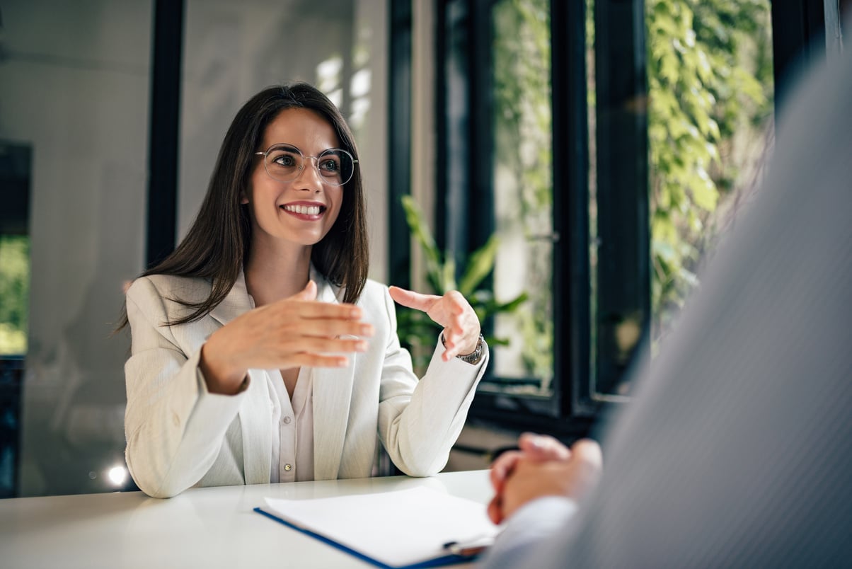 Beautiful female financial adviser talking to a client.